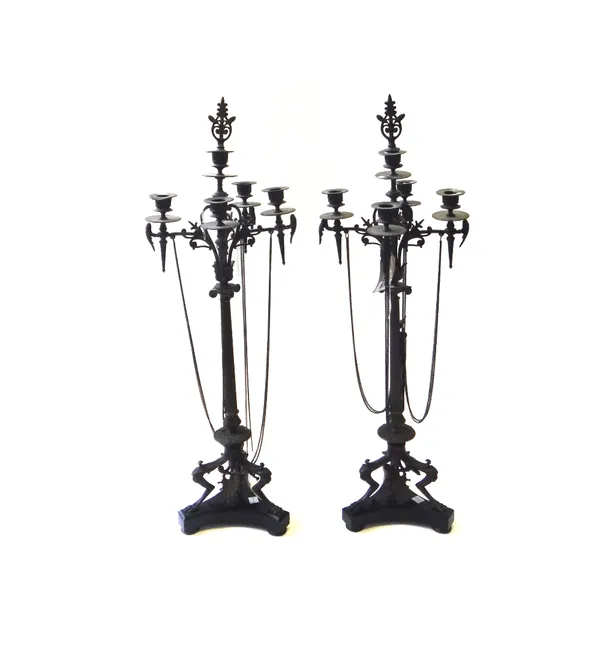 A pair of French bronze five light candelabra, circa 1860, each triform marble base supporting a reeded tapering column and foliate cast sconces, link