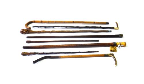 A 17th century Puritan walking stick with piquework ivory pommel (89cm), a Victorian rosewood walking cane with silver pommel (91.5cm), a riding crop