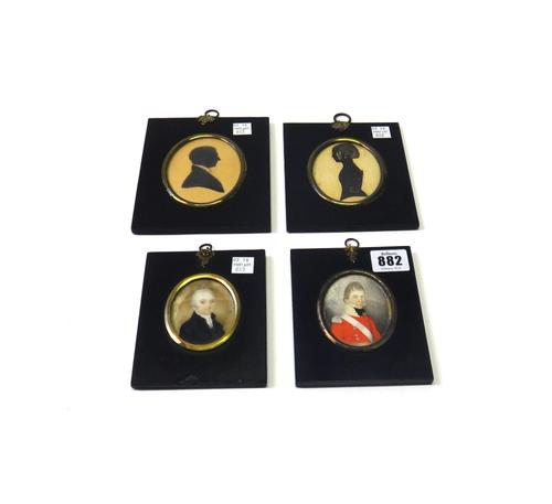 A portrait miniature on ivory depicting a gentleman in a military tunic, dated 1811 to the rear, housed in a metal mounted black wooden frame (the min