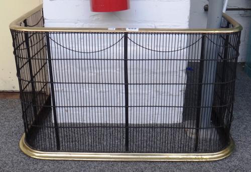 A Georgian wirework brass mounted fire guard, 64cm wide, and a steel fire screen with pierced fleurs de lys type design and wire mesh panel, 61cm wide