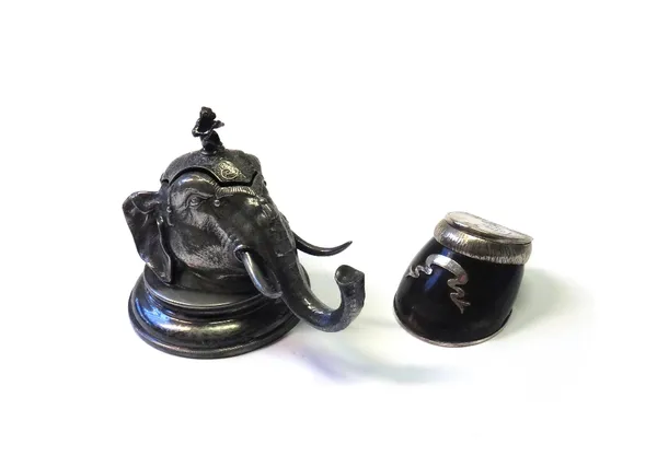 An Indian white metal novelty inkwell, early 20th century, modelled and cast as an elephant head with internal tin reservoir, 12.5cm high, and a horse
