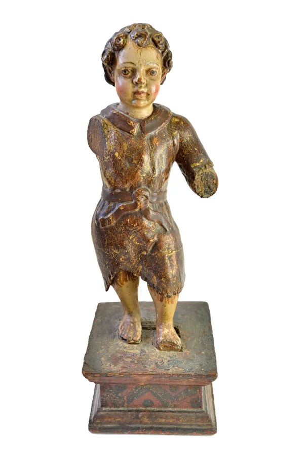 A late 17th century polychrome painted carved wooden figure depicting a young boy on a wooden plinth, (a.f.), 51cm high overall.  Illustrated