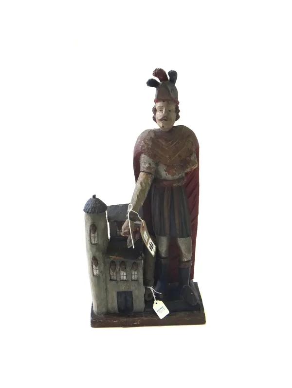 A late 19th century polychrome painted wooden figure of St Florian; depicted emptying a bucket of water onto a burning house, (a.f.), 52cm high.