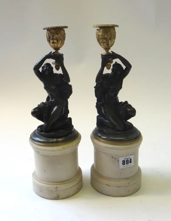 A pair of French gilt and patinated bronze figural candlesticks of Louis XVI style, late 19th century, modelled as two opposing female Bacchante each