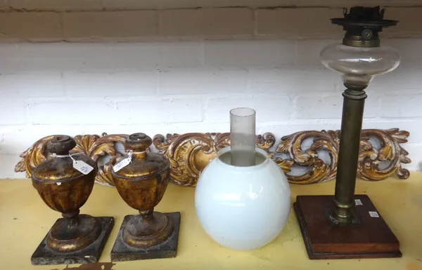 A French brass clock pendulum, 93cm, a pair of giltwood urn finials, 21cm high, an oblong pierced parcel gilt panel and a Victorian brass oil lamp wit