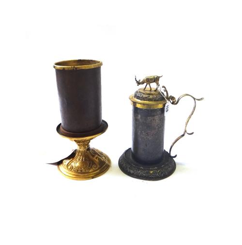 A gilt metal tankard, possibly 18th century Scandanavian, and an Italian gilt metal altar candlestick, 28cm high (2).