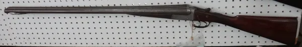 A New Zealand 12 bore double barrel shotgun by Chas Osborne & Co., with plain steel barrels (76.5cm), foliate engraved lockplate and checquered walnut