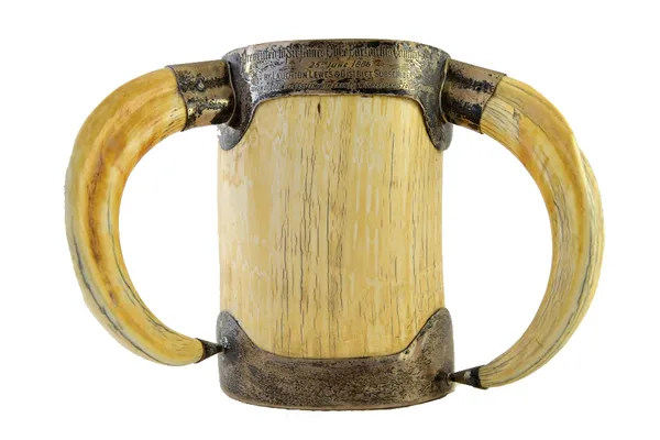 A large Victorian silver mounted ivory cup, London 1884, of cylindrical form with tusk handles and presentation engraved rim, 20.5cm high.  Illustrate