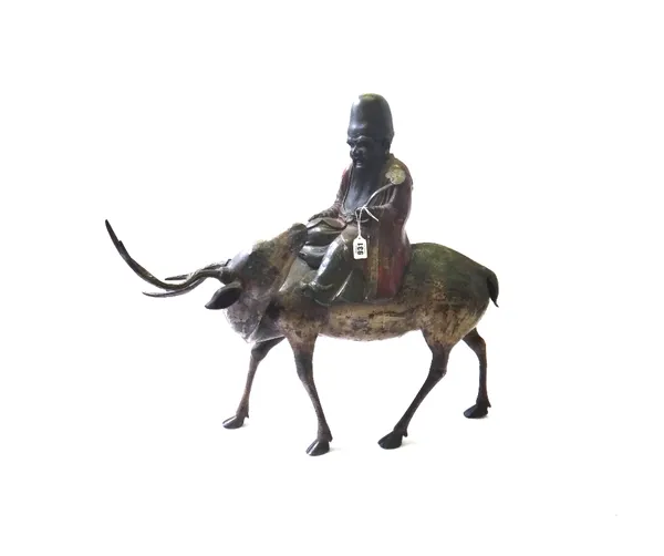A polychrome painted bronze figure of a sage riding atop a reindeer, 19th century, 60cm high.