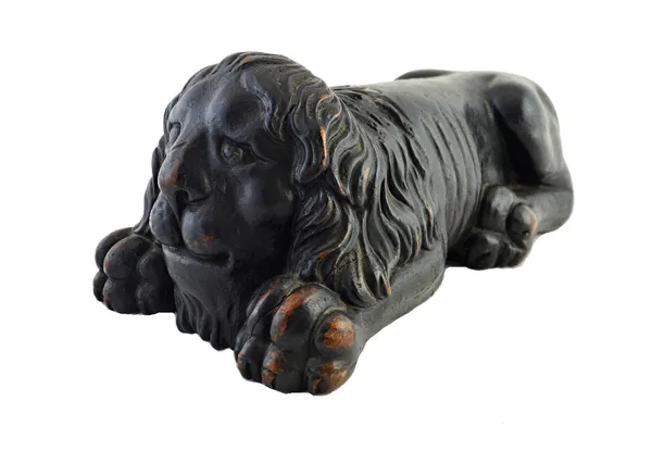 A carved and painted softwood lion, 18th century, of typical form, 39cm wide.  Illustrated