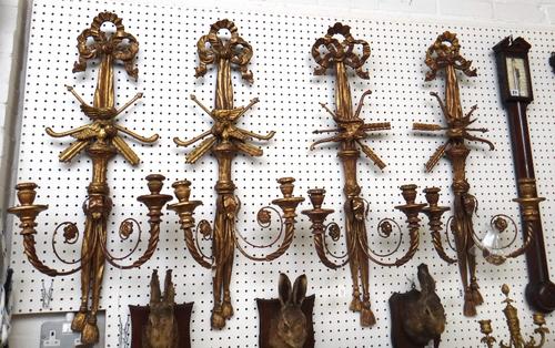 Two pairs of giltwood twin branch wall appliques of George III style, 20th century, each curtain tie back plate applied with ho-ho bird trophies, 94cm