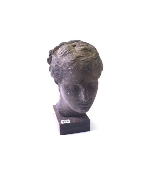A stone bust, early 20th century, modelled as a classical Greek lady, mounted on a wooden rectangular plinth, 30cm high overall.