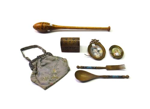 Two gilt metal framed oval miniatures, early 20th century, hand painted on ivory depicting two ladies in Victorian dress, a Russian carved wood servin