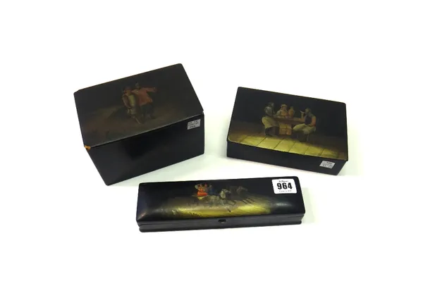 Three Russian black lacquered papier mache boxes, 19th century, the pen box decorated with a Troika scene and with interior stamp to lid, 22.5cm wide