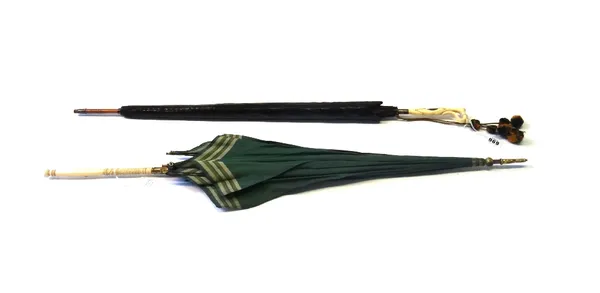 A lady's parasol, early 20th century, with green and red silk over a cane shaft, with a carved ivory handle, in a black sheath, 84.5cm, together with