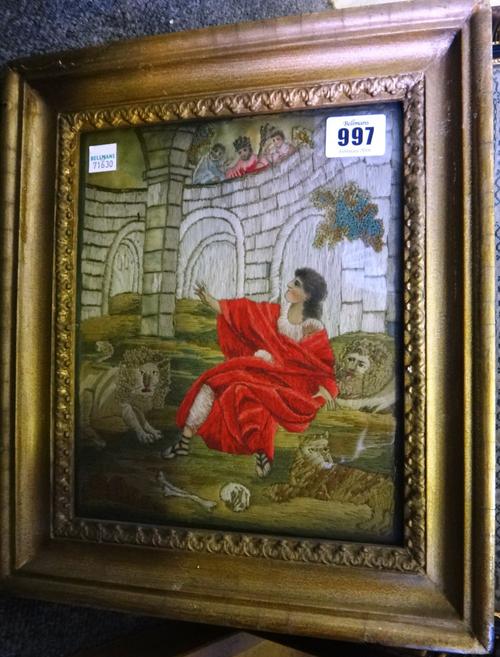 A Regency silk and woolwork picture depicting 'Daniel in the lions den', a pair of needlework pictures depicting Jesus Christ, and one further needlew