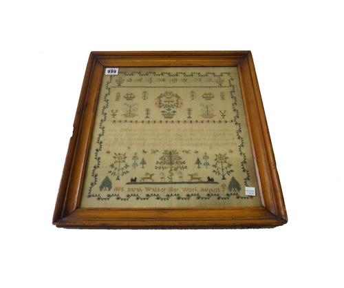A needlework sampler by Sarah Walker, dated 1816, centred with a religious verse over Adam and Eve and the Tree of Life, within a wide foliate border,