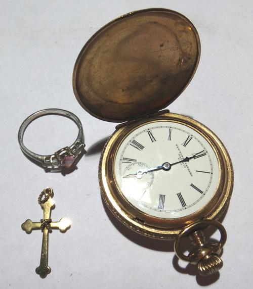 A late 19th century gold plated pocket watch, a small gold cross pendant and a silver and synthetic ring.