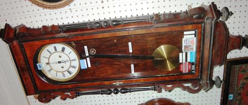 A 19th century walnut and ebonised eight day wall clock.