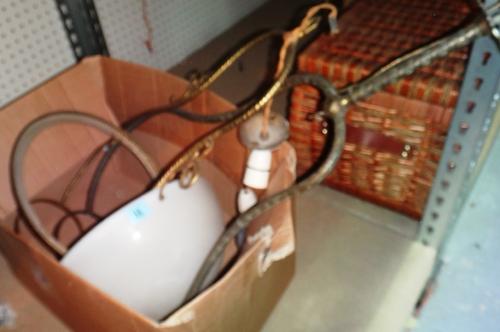 Two gilt metal hanging ceiling lights with one glass shade.