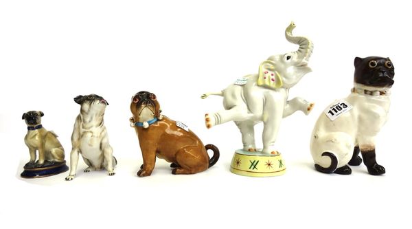 Four Continental porcelain models of pug dogs, and a Nymphenburg performing elephant, 19cm high (5).