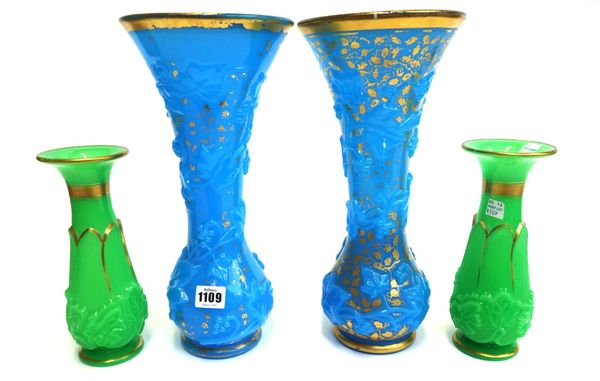 Two pairs of Baccarat opaline moulded glass vases, mid 19th century, the first pair in 'bleu drapeau' glass moulded with fruiting vines, 34.5cm high,