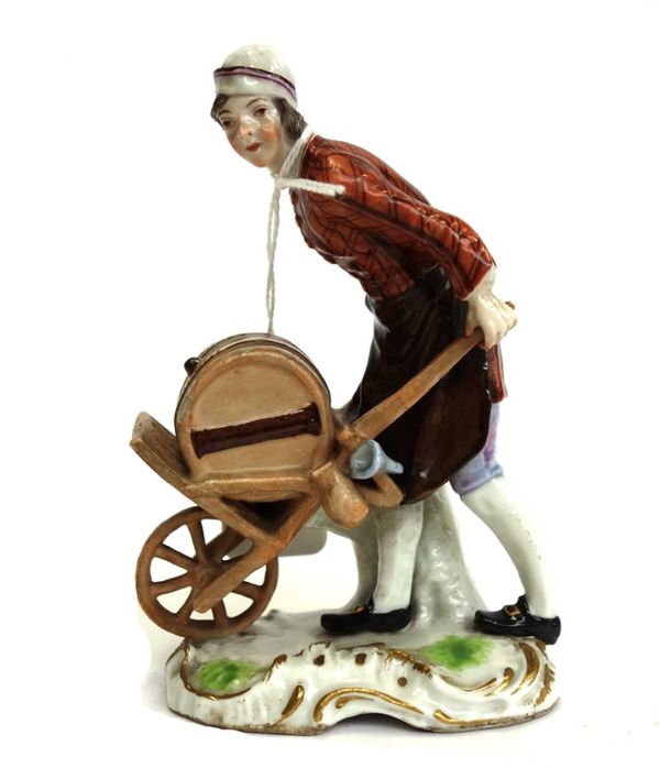 A Samson porcelain figure, late 19th century, modelled as a labourer pushing a cask of wine in a wheelbarrow, raised on a gilt C scroll base, 12.5cm h