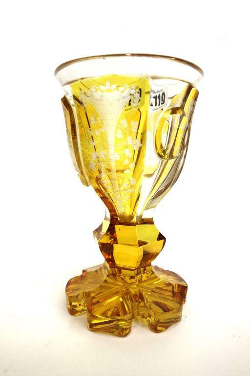 A Bohemian amber etched glass goblet, late 19th century, decorated with a hunting scene over a knopped and faceted stem and shaped foot (a.f), 16.5cm