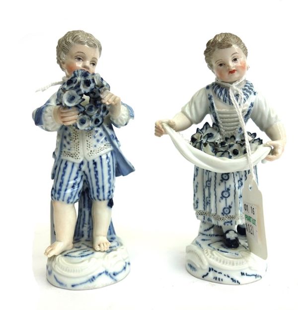 A pair of Meissen porcelain figures, late 19th century, each formerly the top of a cakestand, both decorated in blue against white, the young male fig