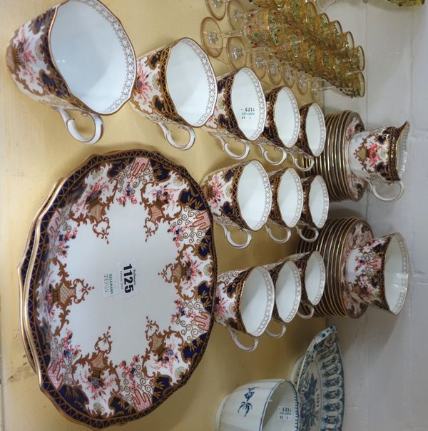 A Royal Crown Derby part tea service, early 20th century, decorated in an Imari pattern and comprising; a milk jug, a sugar bowl, two serving plates,