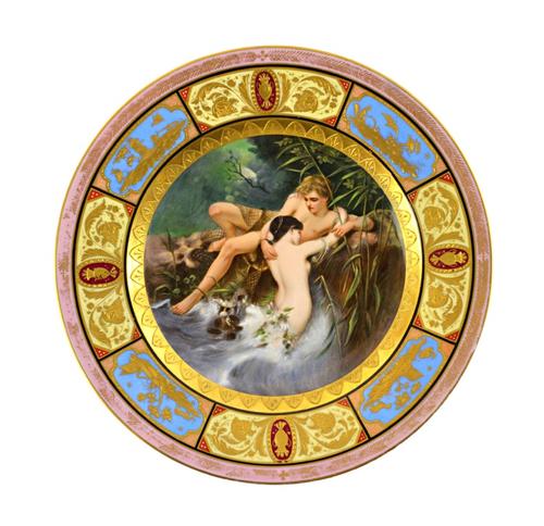 A Vienna style cabinet plate, late 19th century, titled 'Fisher und Nixe', painted with a young man pulling a mermaid from a stream, within a gilt and