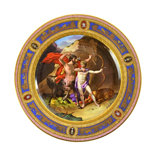 A Vienna style cabinet plate, late 19th century, titled 'Die Underweisung de Achillies' decorated as title within a gilt foliate and multicoloured wid