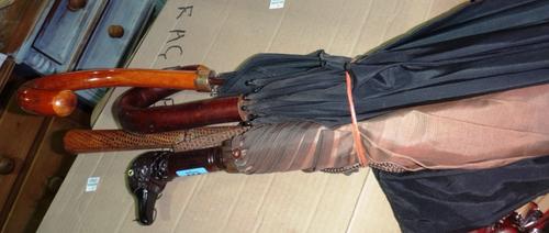 A quantity of assorted walking sticks and parasols.