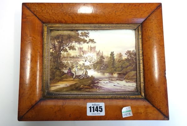 An English porcelain rectangular plaque, mid 19th century, painted with a rustic scene with three figures on a riverbank, with a church in the distanc