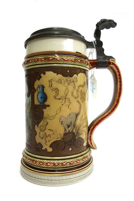 A Mettlach stoneware and pewter mounted stein, incised with a drunken cavalier figure, impressed marks to base, 21cm high overall.