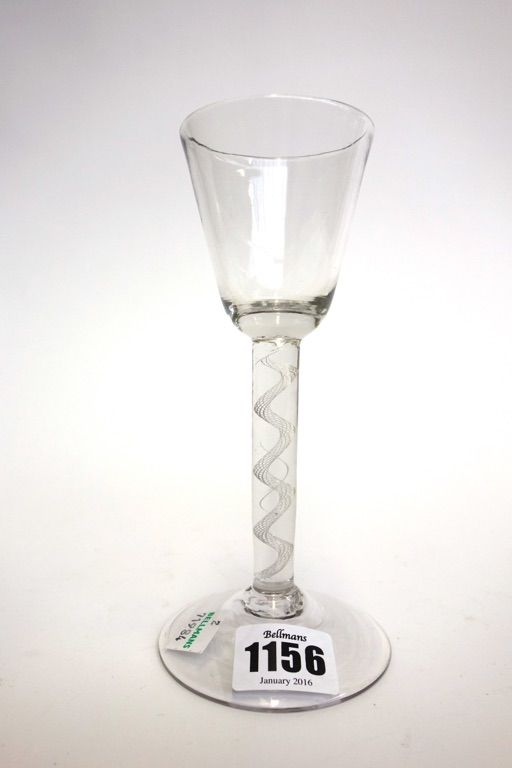 An English wine glass, circa 1750, with rounded funnel bowl and air twist stem, on a circular foot, 17cm high.