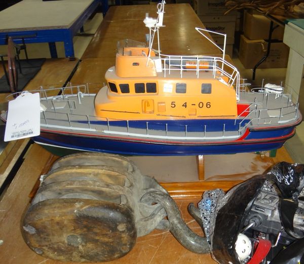 A modern remote controlled RNLI ship and a weighted hook.