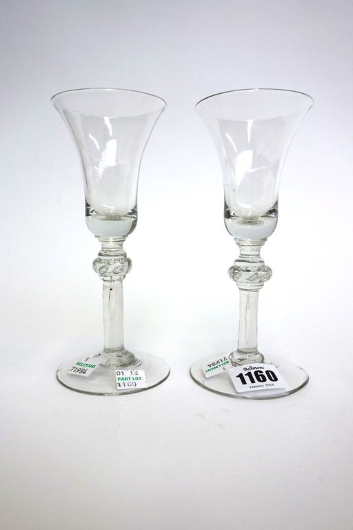 Two similar English wine glasses, circa 1740, with bell bowls and teared annulated knops, on a circular foot, 17cm high (2).
