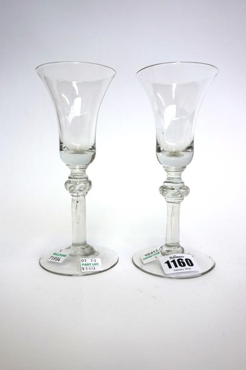 Two similar English wine glasses, circa 1740, with bell bowls and teared annulated knops, on a circular foot, 17cm high (2).
