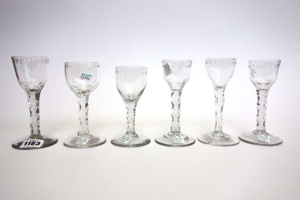 Six similar English engraved wine glasses, circa 1780, each with a facet stem on a circular foot, the tallest 14.3cm high (6).