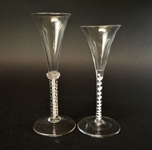 Two English wine glasses, circa 1760, one with trumpet bowl over an annulated collar and mixed twist stem, the other with trumpet bowl on a single ser