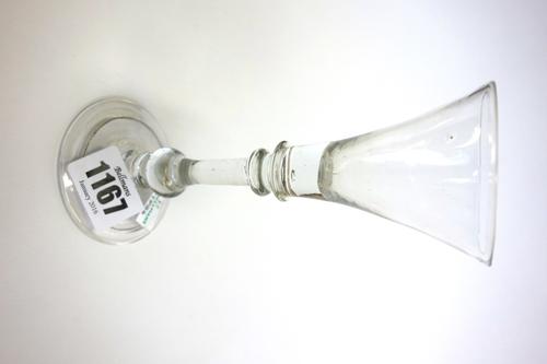 An English wine glass, circa 1740, with trumpet bowl, annulated knop and baluster stem, on a folded circular foot, 15.2cm high.