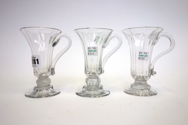 Three English jelly glasses, 18th century, each with a moulded drawn trumpet bowl, two with teared knopped stems, all on a panelled domed foot, 12cm h