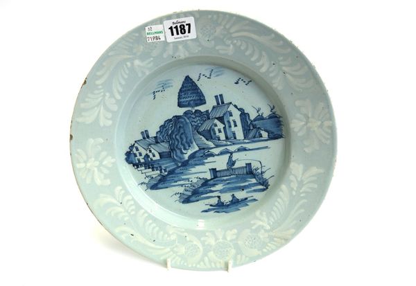 A Bristol delftware blue and white dish, circa 1760, painted with a chinioserie landscape with a figure fishing on an island, inside a bianco-sopra-bi