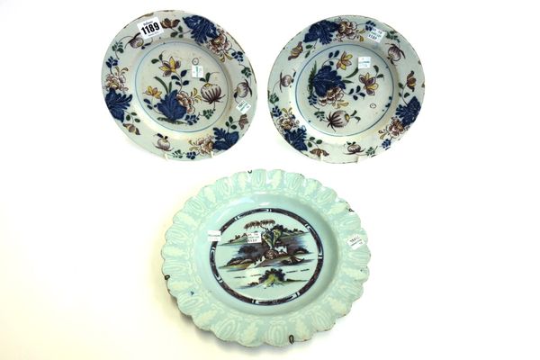 A Bristol delftware polychrome plate, circa 1760, painted with a Chinese island within a bianco-sopra-bianco border and scalloped rim, 26.5cm diameter