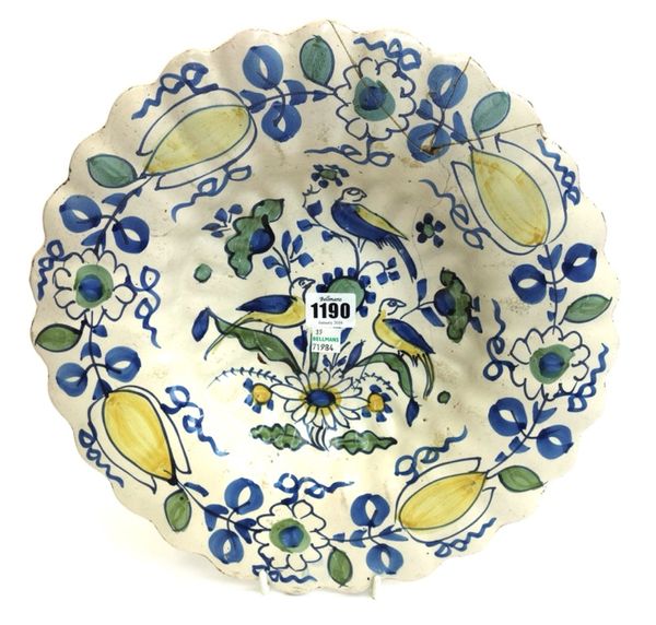 A Dutch Delft polychrome lobed dish, early 18th century, painted with exotic birds within a wide floral border (a.f), 34.5cm diameter.