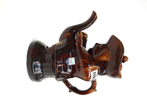 A Staffordshire pottery treacle glazed Snuff Taker toby teapot and cover, 19th century, 27.5cm.high.