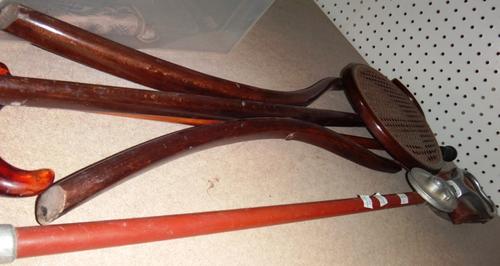 A bentwood shooting stick, another shooting stick and a walking cane with a faux amber handle.