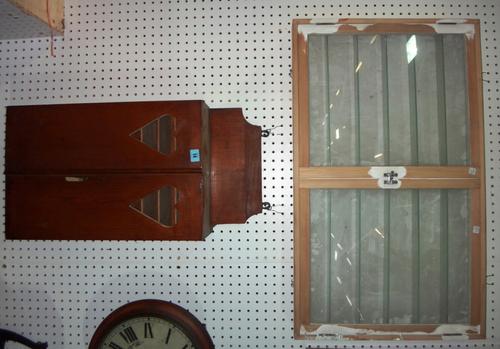 An early 20th century oak wall cupboard with pierced heart decoration, together with a 20th century beech wall mounted display cabinet.