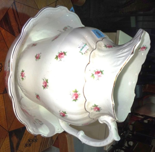 A ceramic jug and bowl decorated in white with pink roses.